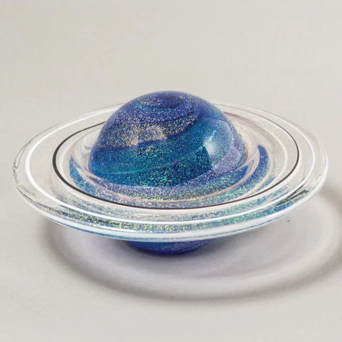 Beautiful glass paperweight with intricate rings of Saturn design, perfect for adding a celestial touch to any desk.