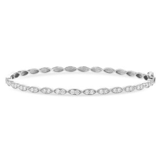 Elegantly crafted 14K white gold bangle bracelet with 0.73CTW of diamond milgrain edges, perfect for any occasion.