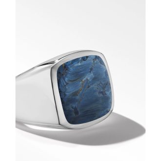 This stunning signet ring boasts a rich, rectangular Pietersite stone with mesmerizing blue hues. Skillfully set in sterling silver, it exudes a timeless elegance. Its distinctive design and color patterns ensure the ring stands out. Ideal for daily wear or special occasions. It's perfectly sized for a size 10 finger.