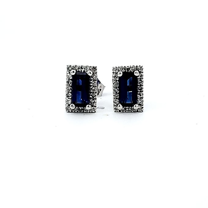 These enticing rectangle shaped, stud earrings feature beautiful 6X3mm created sapphires at their heart, encased by 10 karat white-gold. The 0.12 carat weight round cut diamonds graciously encircle the sapphires, providing an enticing halo effect, radiating luxe style. Introduced as an essential beauty for your jewelry collection.