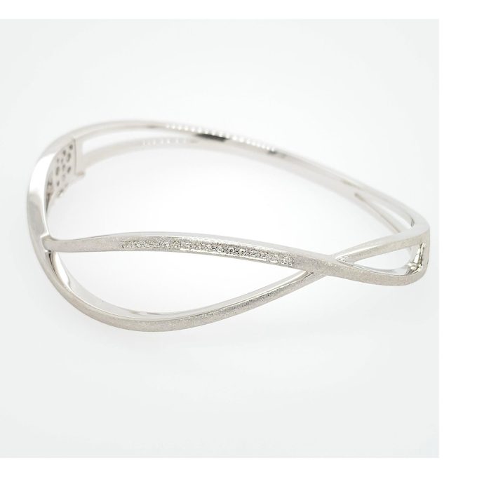Experience elegance with this intricately designed bracelet featuring a unique open twist style, handcrafted in brushed stainless steel. Embellished with stunning white sapphire stones, its sleek design lends a contemporary edge to any look. This bangle is not just an accessory but a statement piece, capturing the eye with its subtle sparkle.