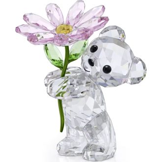This adorable sculpture depicts a cute, whimsical bear presenting a delicate, yellow daisy. Fashioned from sparkling crystal, it exudes vibrancy and sentimentality. Itas a perfect item to give away as a token of love, friendship, or just because. A decorative keepsake, certain to brighten any interior space. Craftsmanship and attention to detail make it an exquisite gift.