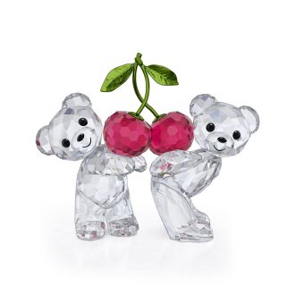 Cherish mesmerising moments with this charming crystal figurine pair. Expressing a heartwarming sentiment, these bundled bears denote an innate bond. Brought live by Swarovski, it's a perfect representation of companionship. Its facets subtly reflect light for a sparkling effect, making it a beautiful addition to any collection or an endearing gift for a loved one.