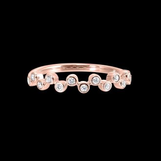 This spectacular diamond stack ring features a striking offset design set in 14k rose gold. Adorned with 13 round bezel-set diamonds, which all combine to deliver a total 1/5 carat weight, this ring beautifully captures elegance and luxury that's sure to leave a lasting impression. Parse any outfit with pure sophistication.