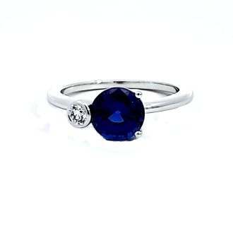 This fashion ring features two beautiful stones - a 0.07 CTW diamond and a large sapphire, set in luxurious 14KT white gold. The lustrously two-stone design makes it an elegant addition to any jewelry collection and a perfect statement piece for occasions demanding a glam touch.