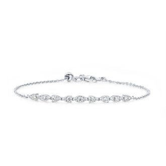 Experience refined elegance with this striking 18 karat white gold bolo bracelet. Carefully crafted, it features an aerial dewdrop pattern and showcases a total of 0.41 carats of 21 round-cut, Hearts on Fire diamonds that shimmer brilliantly for a timeless appeal. Its adjustable design guarantees a perfect fit for an unparalleled comfort and sophistication.