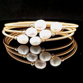 This is a unique and stylish jewelry piece featuring a split design with a refreshing yellow wire frame. It's highlighted with a genuine, freshwater pearl providing an unexpected touch of elegance. Perfect as a standalone piece or paired with additional bangles, offering endless versatility to your accessory collection.