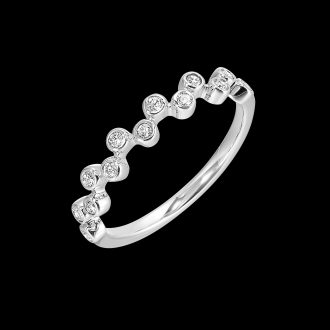 Effortlessly sophisticated, this stackable diamond ring boasts 13 round bezel-set brilliants with an accumulated weight of 1/5 carats. Its 14 karat white gold setting showcases a captivating offset design. Exceptional sparkle and unmistakable style coalesce to make this gorgeously unique jewelry piece a truly perfect addition to any ring stack or fine jewelry collection.