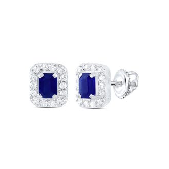 Adorn the perfect elegancy with these enticing blue sapphire stud earrings! Set in dazzling 14-karat white gold, the design features enchanting 4x3mm emerald-cut sapphires surrounded by a sparkling halo. The total diamond weight is 1/5 carat round diamonds bestowing an impressive luster, for the ultimate statement of sophistication.